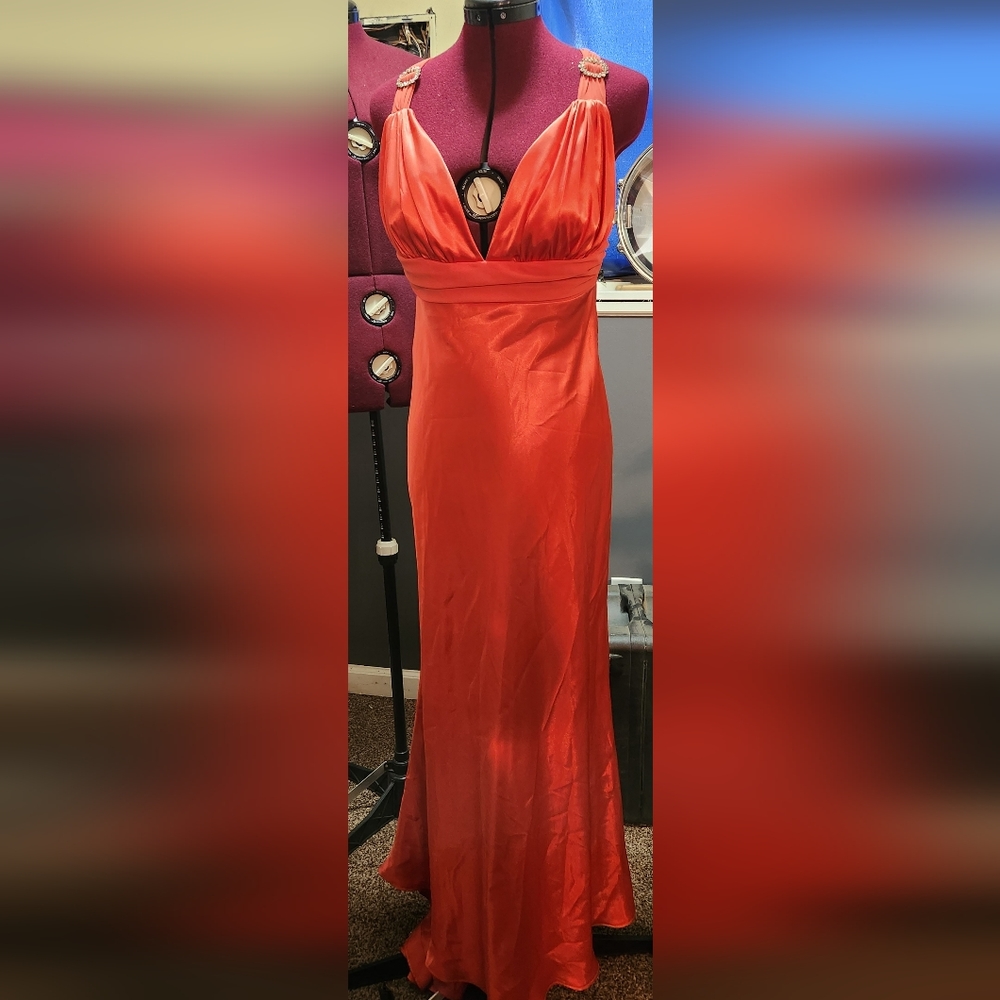 Peach gown with rhinestone accents on the shoulders and back